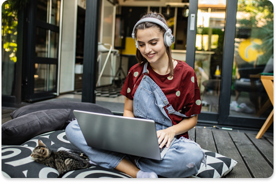teenager looking computer with headphones